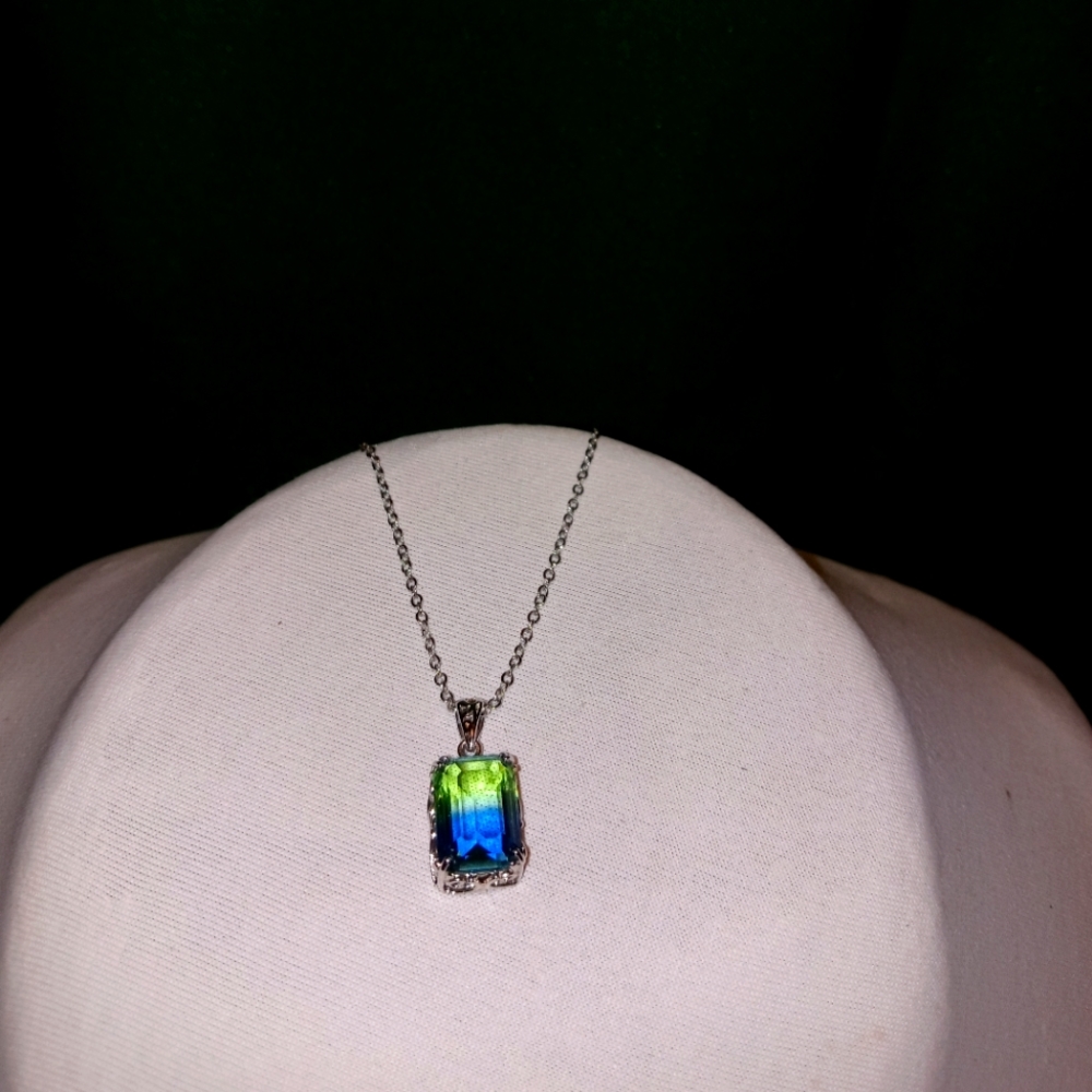 Green and blue crystal mounted onto silver pendant with silver chain